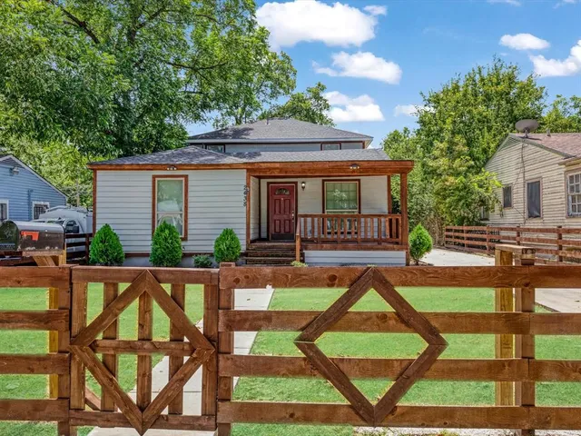a view of house with backyard porch and sitting area