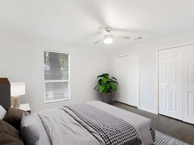 a bedroom with a bed and a window