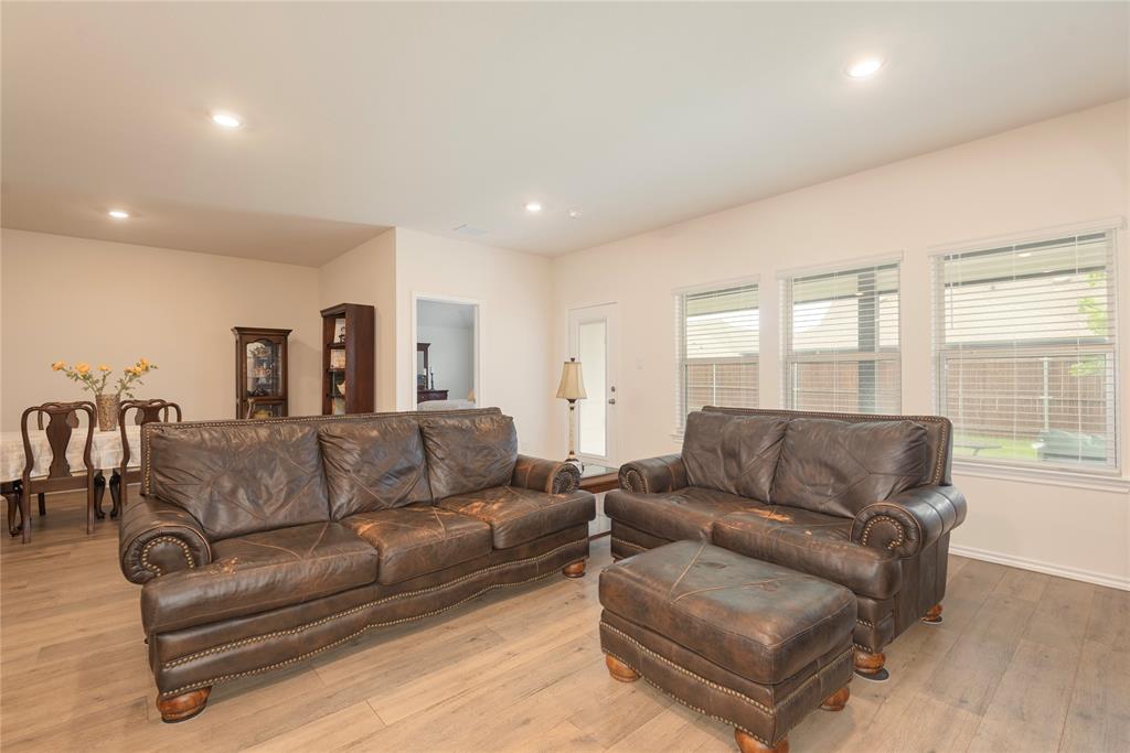 723 Primrose Lane Pilot Point, TX 76258 - Photo 18 of 37 Living area with light wood finished floors and recessed lighting overlooking the large covered patio area.