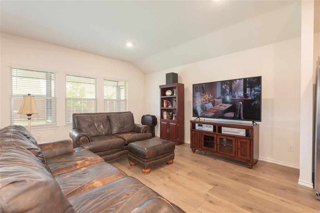 723 Primrose Lane Pilot Point, TX 76258 - Photo 19 of 37 Living area featuring vaulted ceiling, light wood-style floors, and recessed lighting