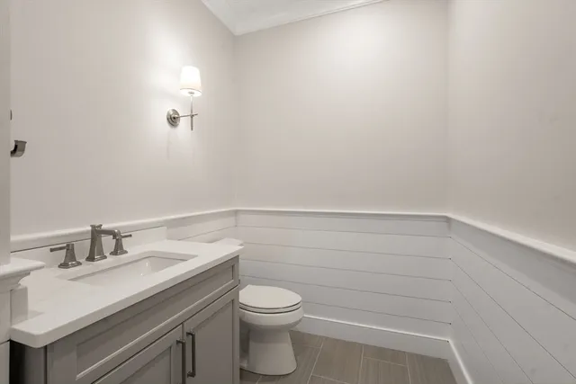 a bathroom with a sink a toilet and vanity