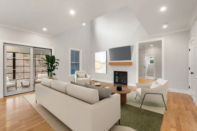 a living room with furniture a fireplace and a table