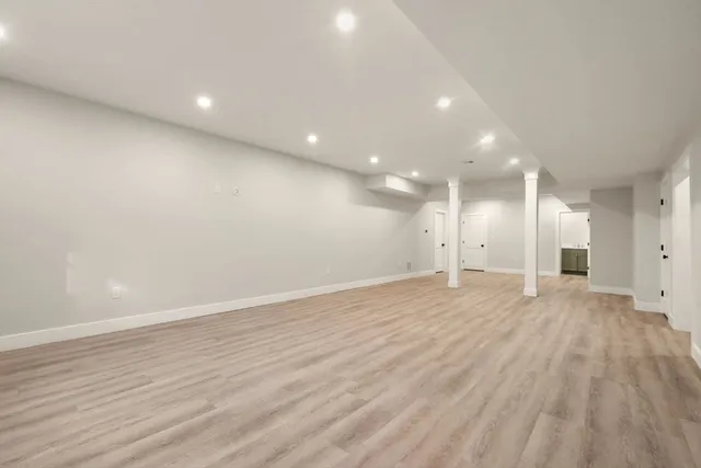 a view of an empty room with wooden floor