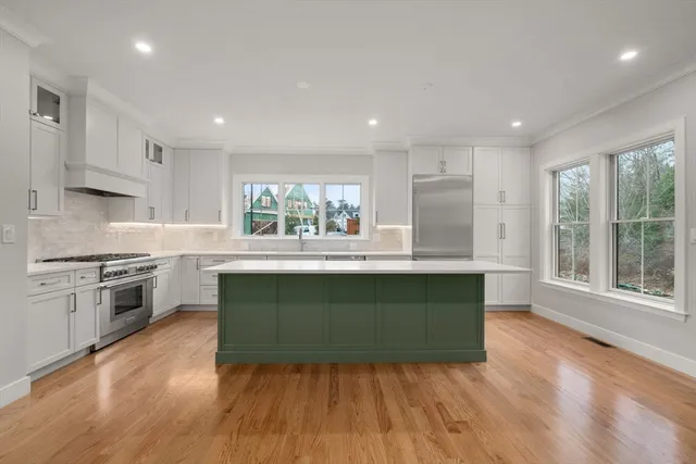 a kitchen with granite countertop a stove top oven sink and cabinets