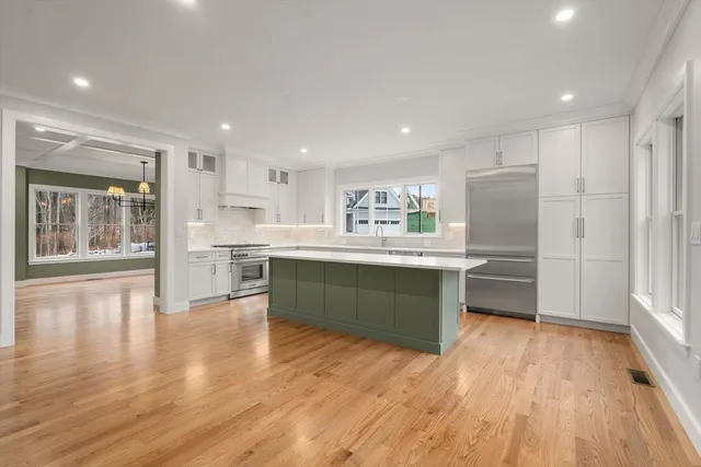 a kitchen with a wooden floor and window