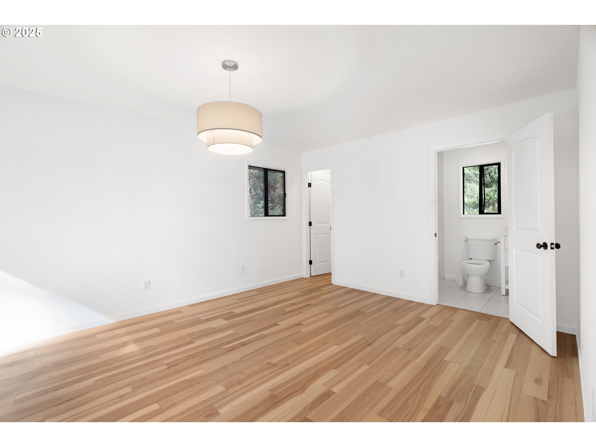 95708 Horton Lane Brookings, OR 97415 - Photo 16 of 46 a view of an empty room with wooden floor and a window