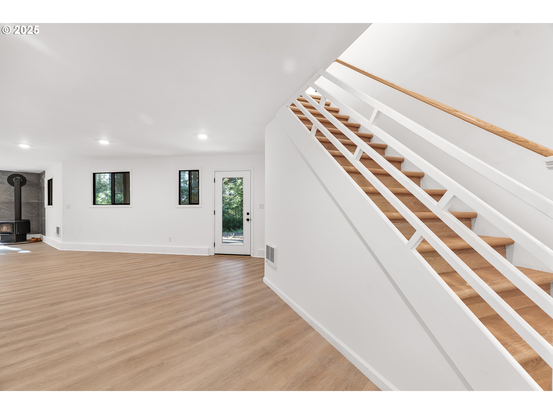 95708 Horton Lane Brookings, OR 97415 - Photo 31 of 46 a view of an empty room with wooden floor