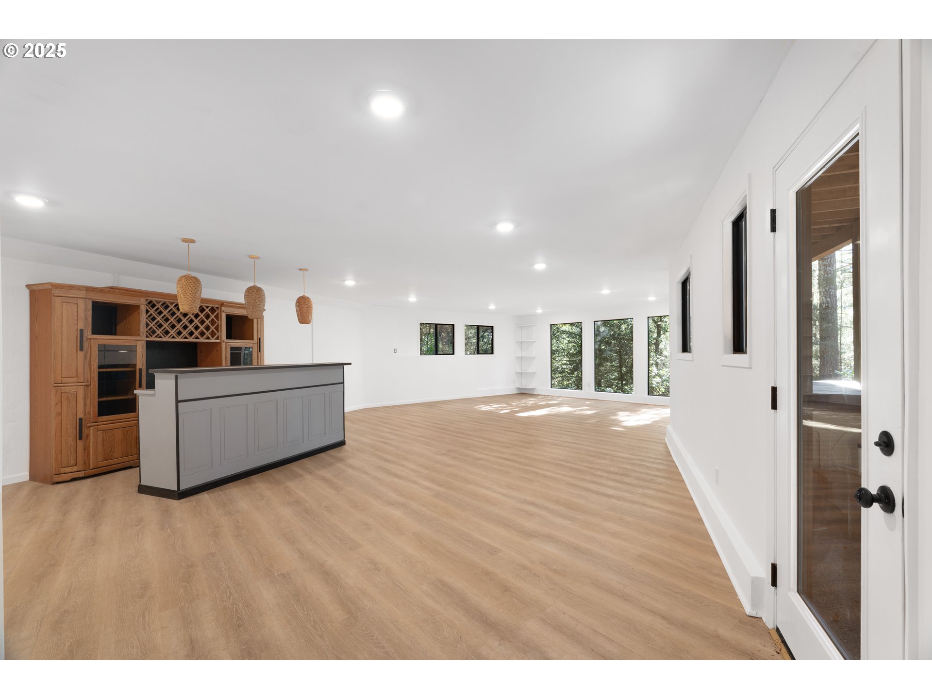 95708 Horton Lane Brookings, OR 97415 - Photo 33 of 46 a view of a living room a kitchen with furniture and wooden floor