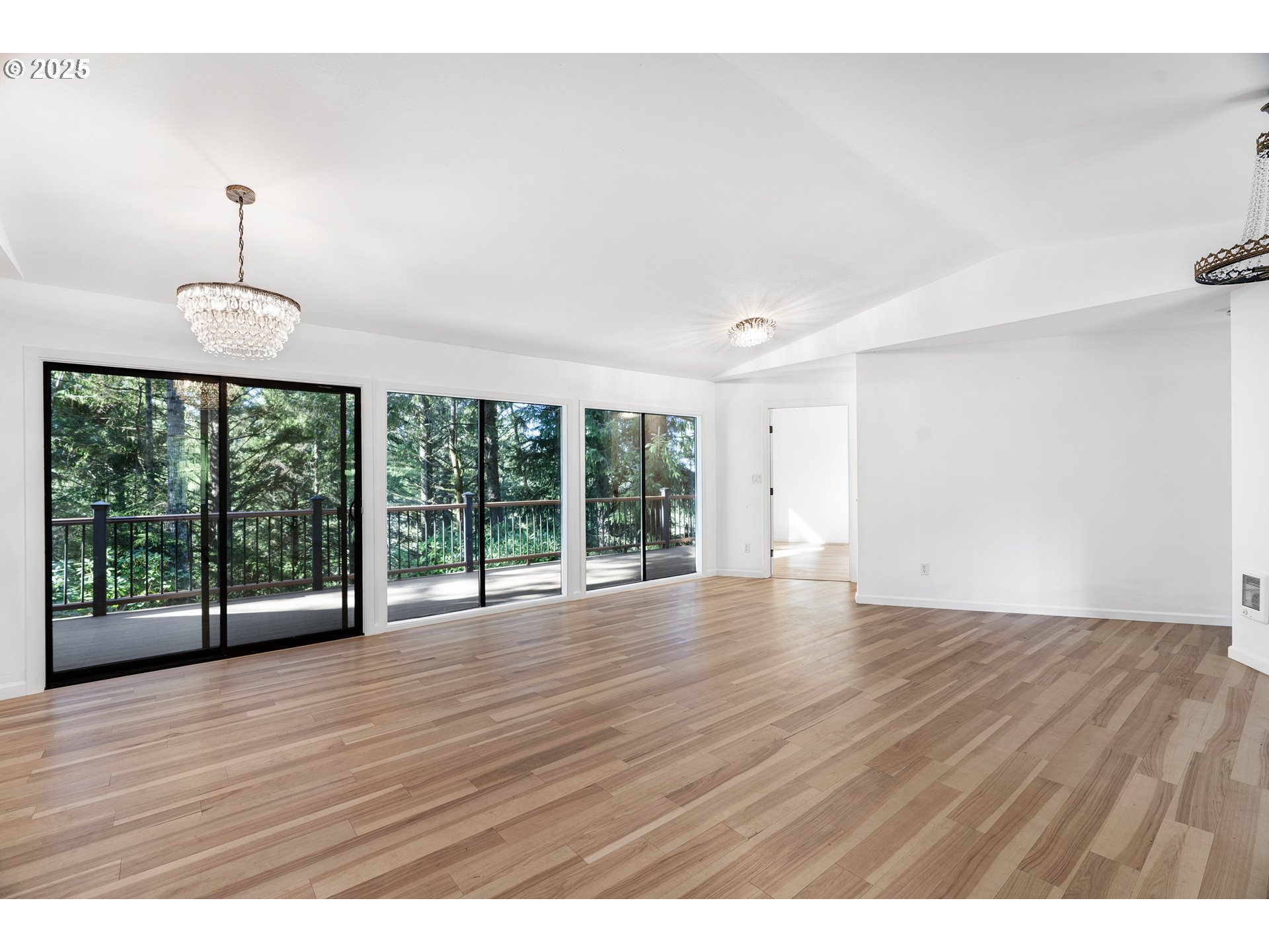 95708 Horton Lane Brookings, OR 97415 - Photo 9 of 46 a view of an empty room with wooden floor and a window