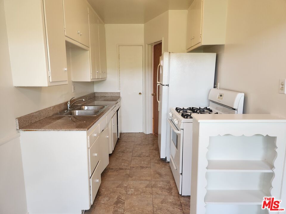 939 North Stanley Avenue, Unit 6 West Hollywood, CA 90046 - Photo 3 of 11 a kitchen with sink a stove and refrigerator