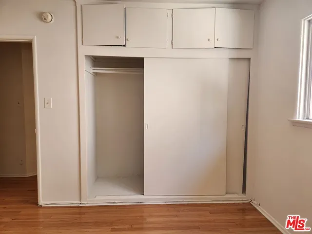 a view of cabinets and wooden floor