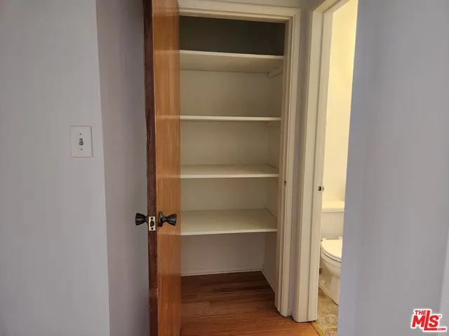 a view of walk in closet with empty racks