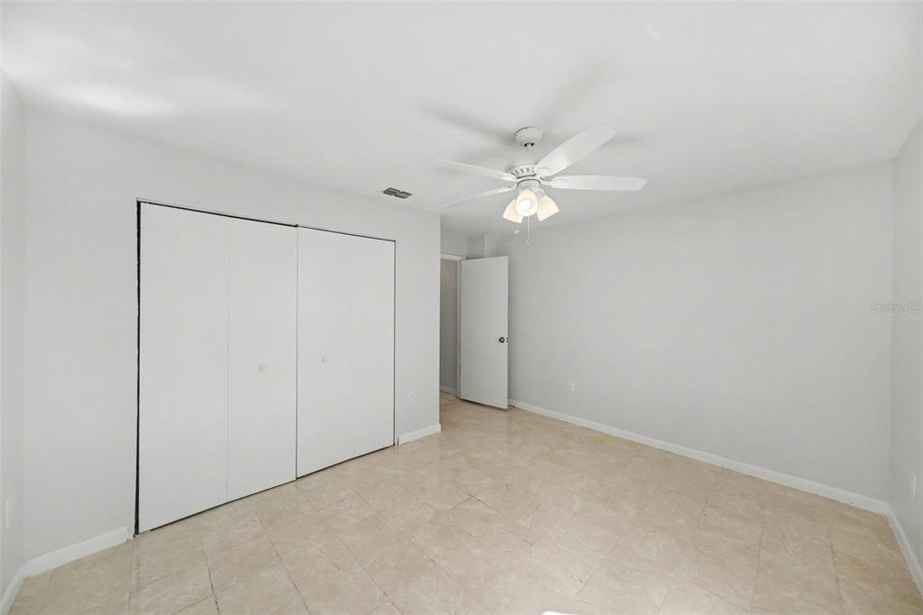113 Ruskin Avenue Spring Hill, FL 34606 - Photo 19 of 32 an empty room with a ceiling fan and a window