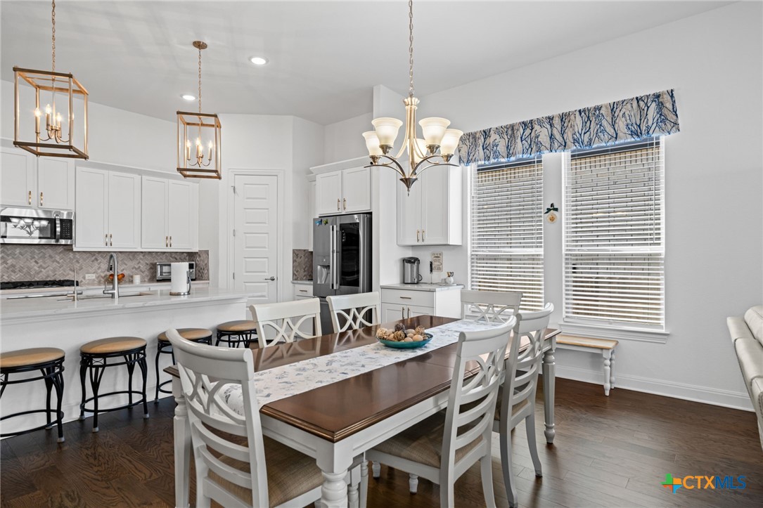 3009 Sage Ranch Drive Leander, TX 78641 - Photo 14 of 43 a view of a dining room with furniture window and wooden floor