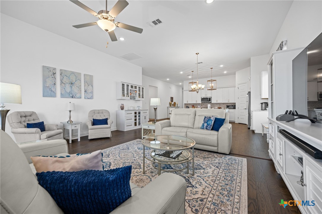3009 Sage Ranch Drive Leander, TX 78641 - Photo 16 of 43 a living room with furniture kitchen view and a chandelier