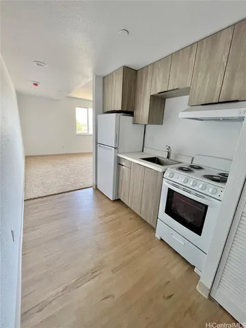 a kitchen with granite countertop a stove and a microwave