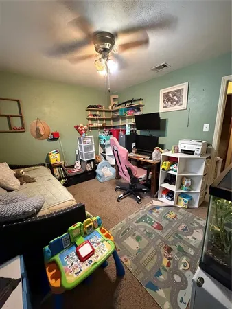 a bedroom with bed and a chandelier