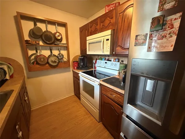 a kitchen with stainless steel appliances granite countertop a sink and a stove
