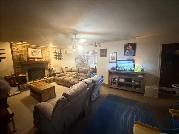 a living room with furniture a fireplace and a flat screen tv