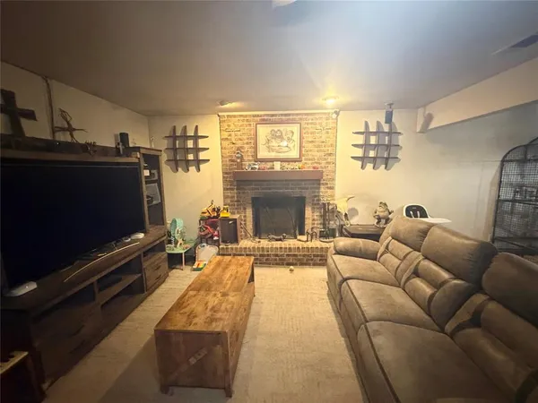 a living room with furniture flat screen tv and a fireplace