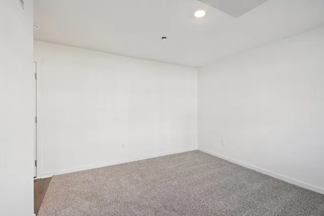 a bedroom with a bed and a night stand