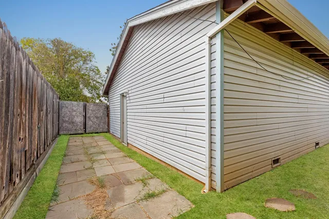 a view of a backyard with wooden fence