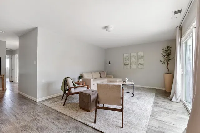 a workspace room with furniture and wooden floor