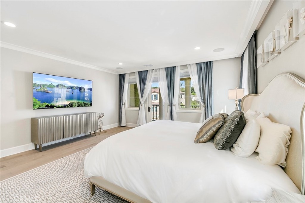 65 Rockinghorse Irvine, CA 92602 - Photo 24 of 43 a bedroom with a bed and a flat screen television