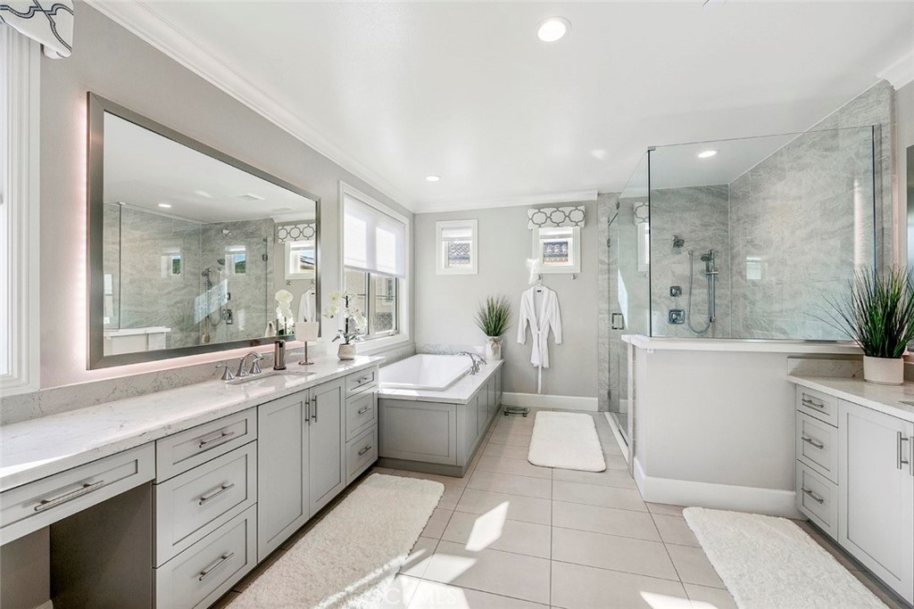 65 Rockinghorse Irvine, CA 92602 - Photo 27 of 43 a large bathroom with a double vanity sink a large mirror a bathtub and shower