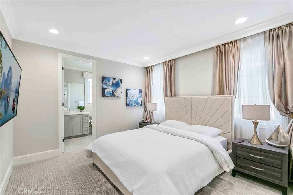 65 Rockinghorse Irvine, CA 92602 - Photo 37 of 43 a bedroom with a large bed and a chandelier