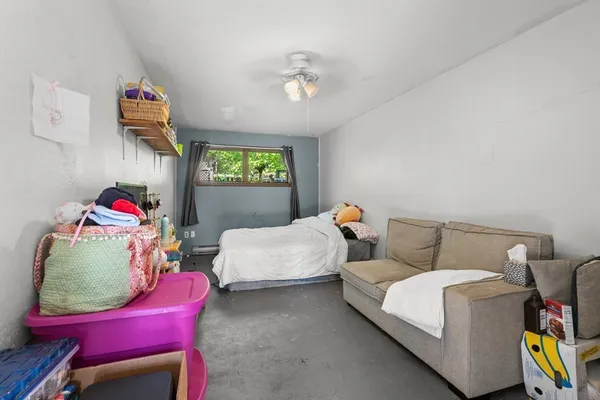 a bedroom with furniture and a chair