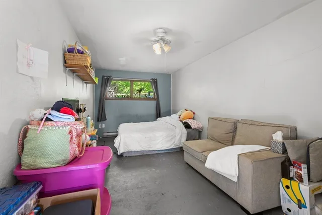 a bedroom with furniture and a chair