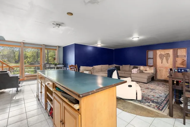 a kitchen with stainless steel appliances granite countertop a sink counter space and a large window