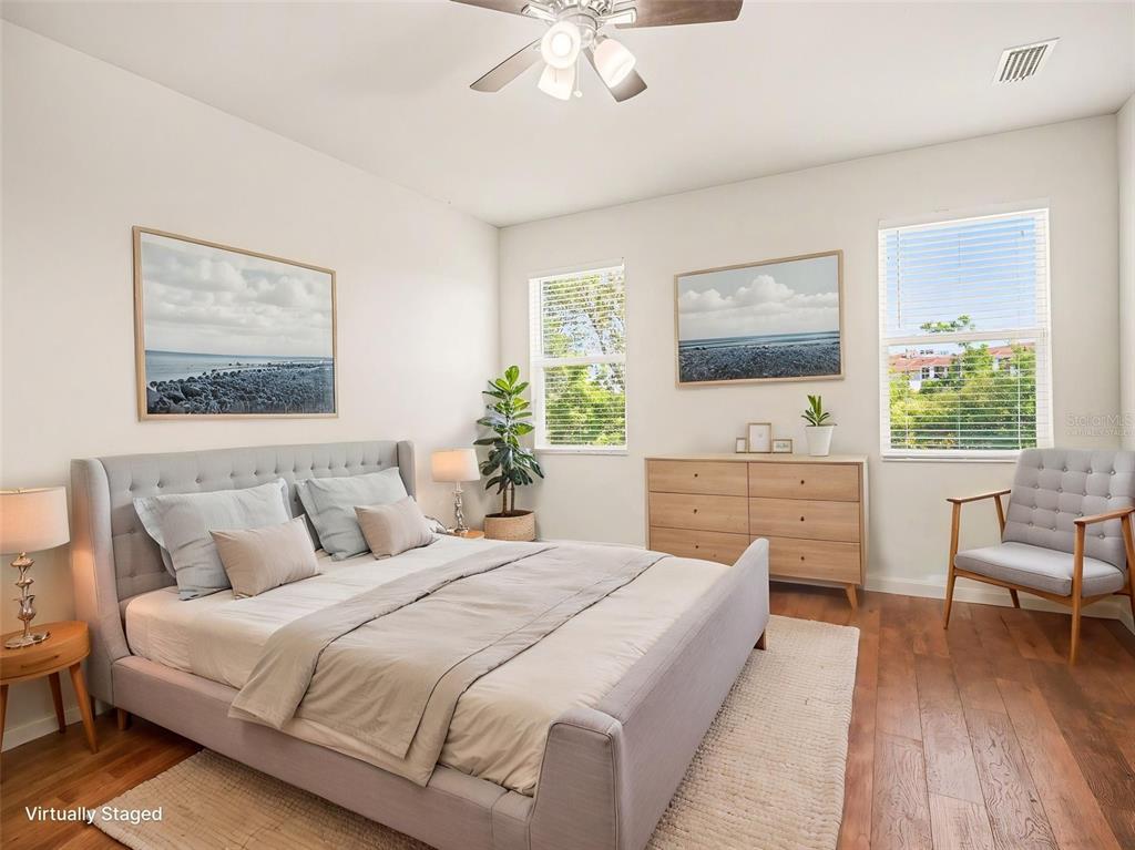 4429 Conchfish Lane Osprey, FL 34229 - Photo 8 of 20 a bedroom with a bed and a flat screen tv
