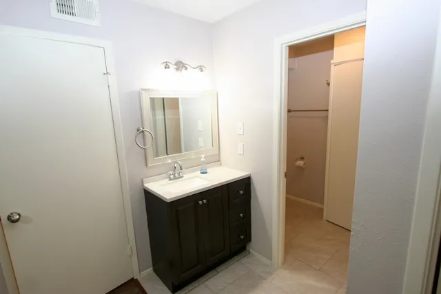 a bathroom with a sink and mirror
