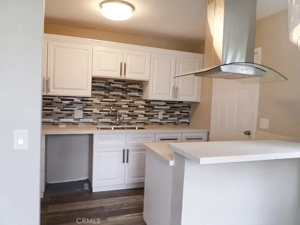 a kitchen with stainless steel appliances granite countertop a sink and a stove