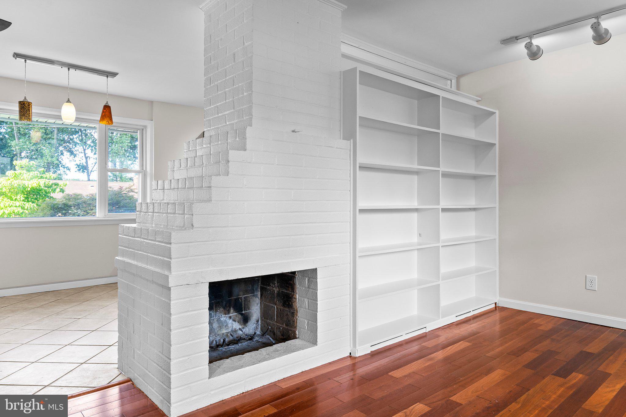 5930 Atteentee Road Springfield, VA 22150 - Photo 12 of 30 a view of a livingroom with a fireplace and window