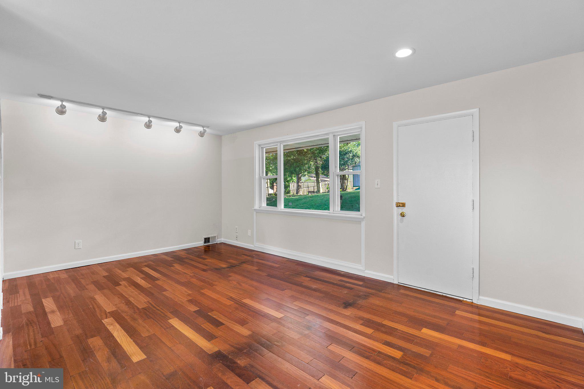 5930 Atteentee Road Springfield, VA 22150 - Photo 15 of 30 a view of an empty room with wooden floor and a window