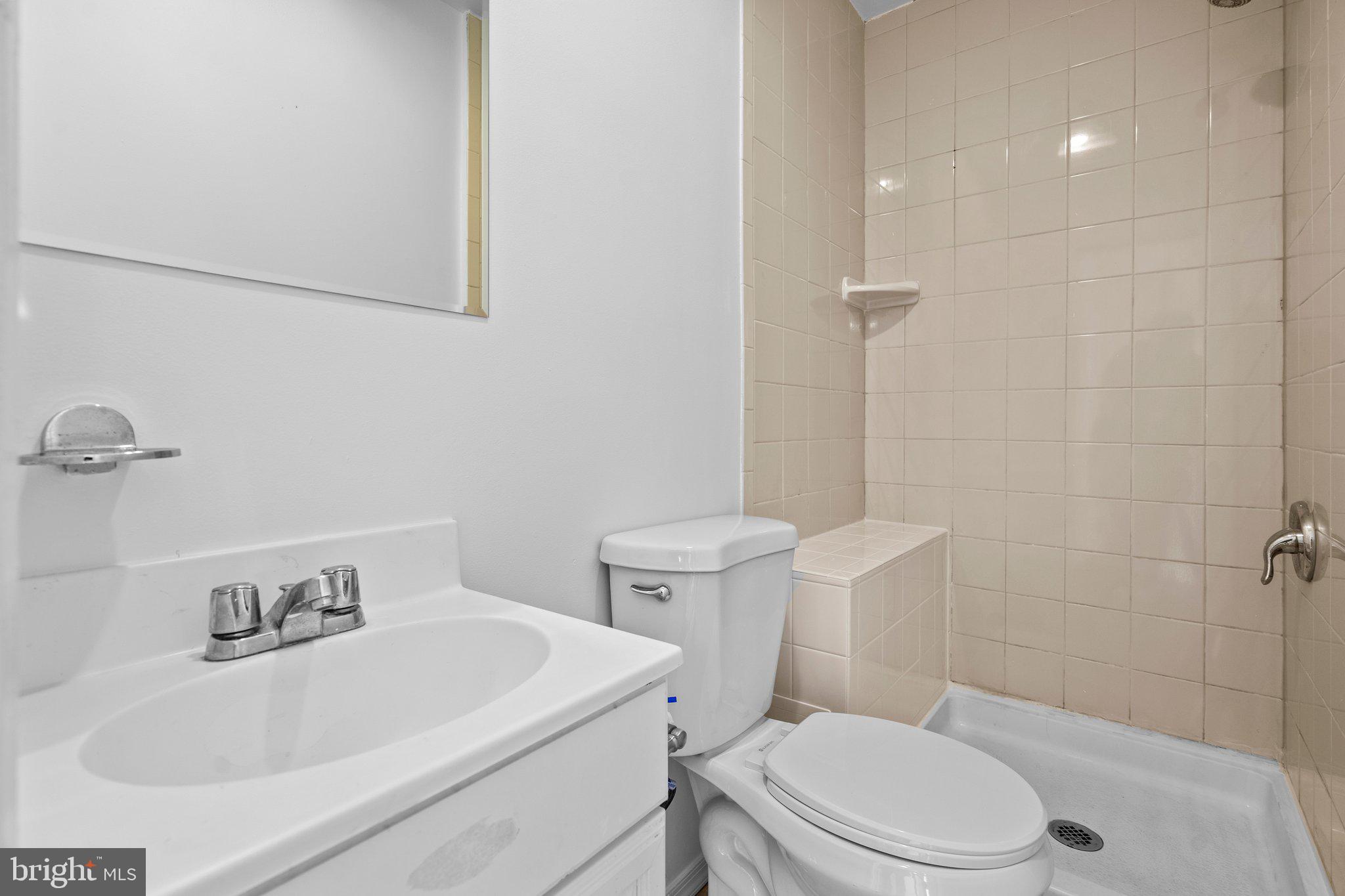 5930 Atteentee Road Springfield, VA 22150 - Photo 25 of 30 a white toilet sitting next to a bathroom sink