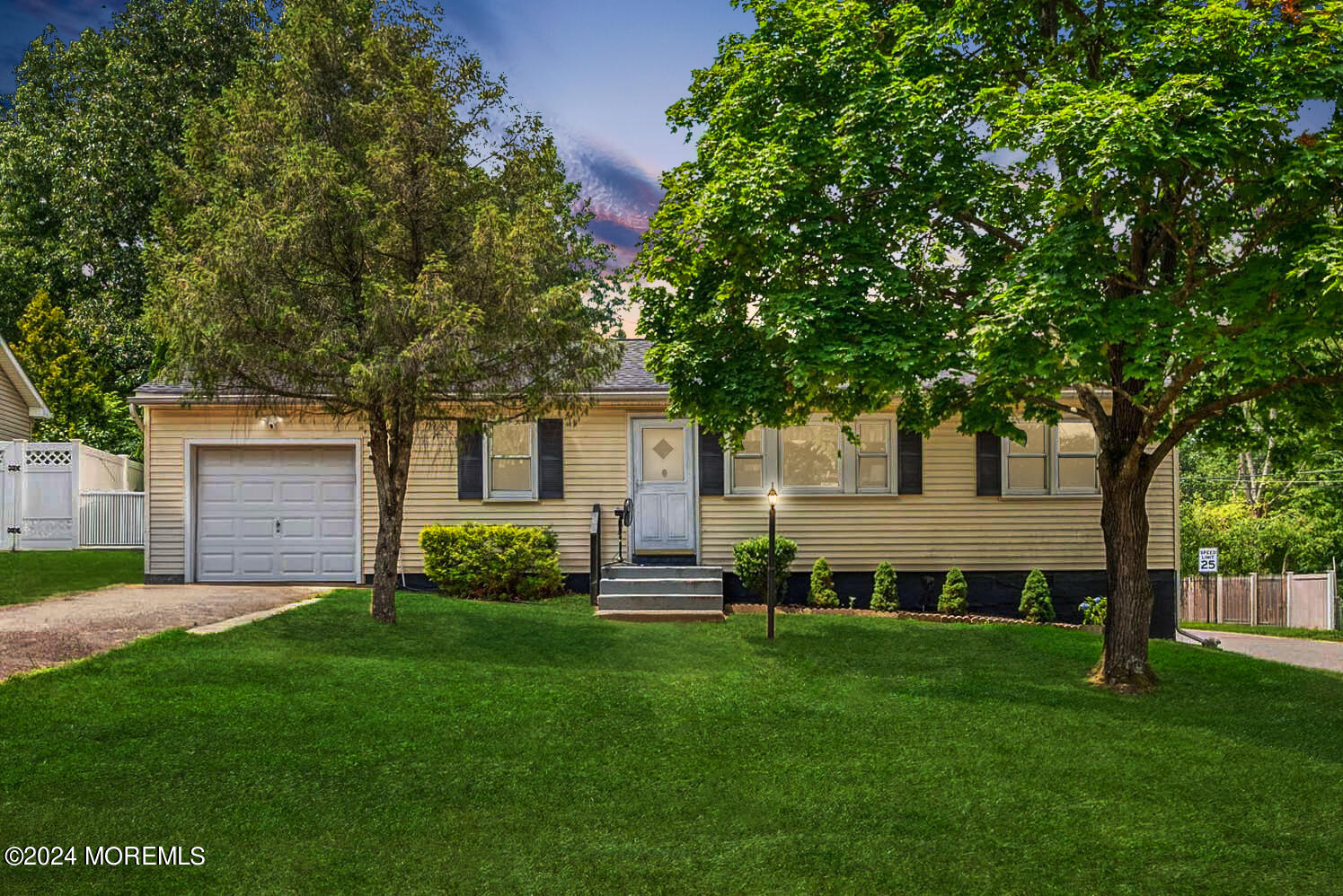 74 Pinewood Road Howell, NJ 07731 - Photo 1 of 24 a front view of a house with a garden and yard