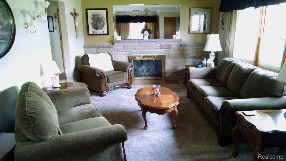 10547 Reeck Road Allen Park, MI 48101 - Photo 11 of 30 LIVING ROOM WITH CUSTOM SANDSTONE GAS LOG FIRPLACE AND HUGE BAY WINDOW.