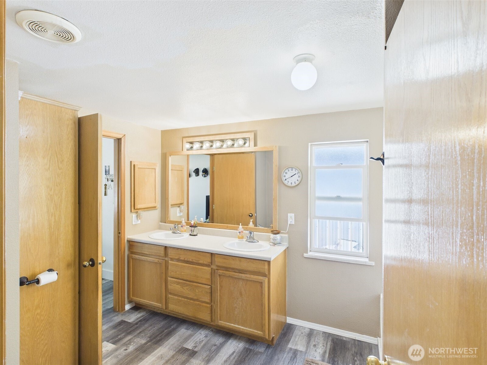 241 Wolf Fork Road Dayton, WA 99328 - Photo 12 of 40 a bathroom with a double vanity sink a mirror and a shower