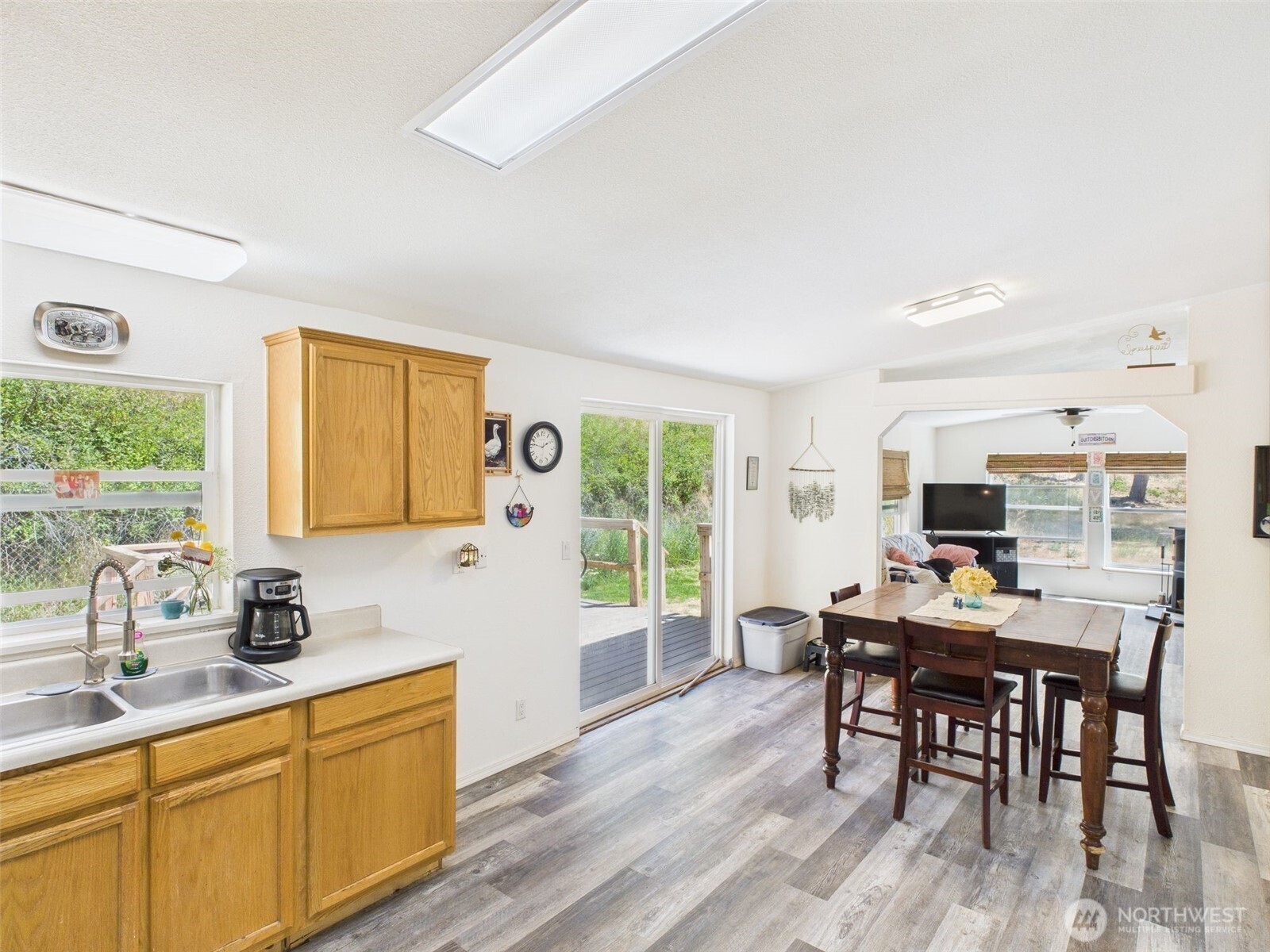 241 Wolf Fork Road Dayton, WA 99328 - Photo 20 of 40 a kitchen with kitchen island granite countertop a dining table chairs and a wooden floor