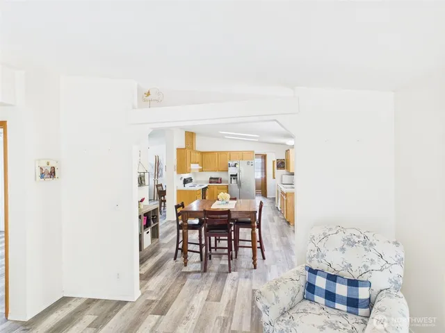 a dining room with furniture and wooden floor