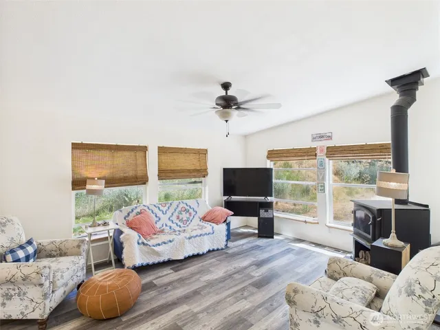 a bedroom with furniture and a large window