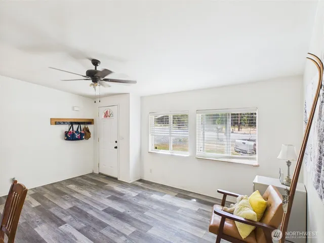 a view of a workspace with furniture and a window