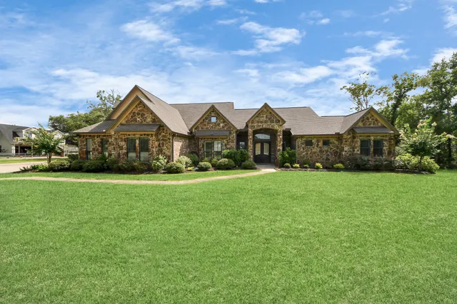 a front view of a house with a garden