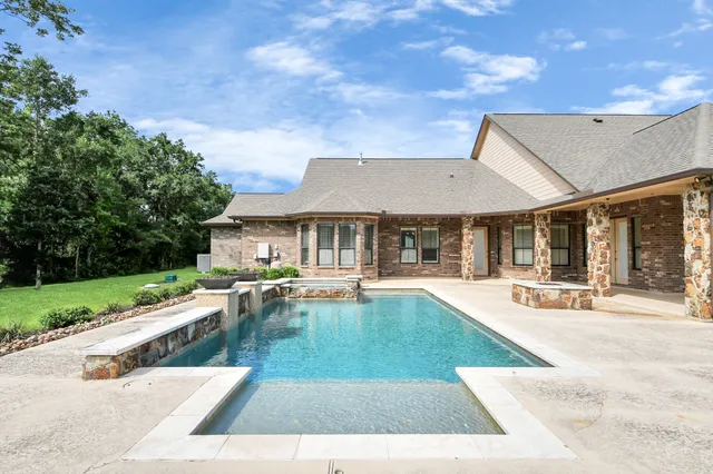 a view of a backyard with sitting area