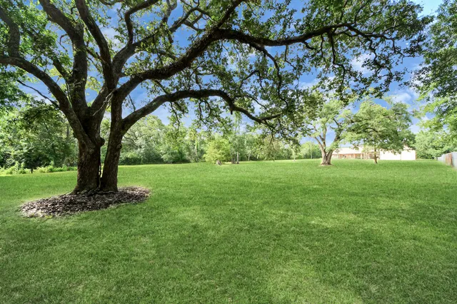 a view of a very nice looking dining room with furniture a chandelier