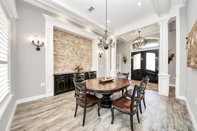 a view of a dining room with furniture and chandelier